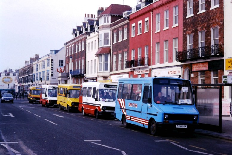 a line up of minibuses at Kings Statue Weymouth